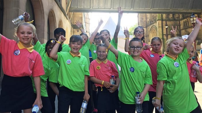 Pike Fold Primary singers punch the air to celebrate a job well done