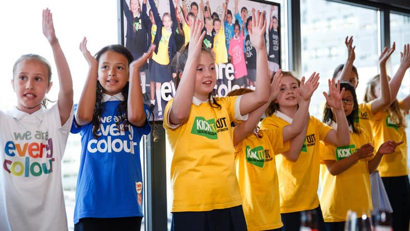 The choir performs the Kick It Out song