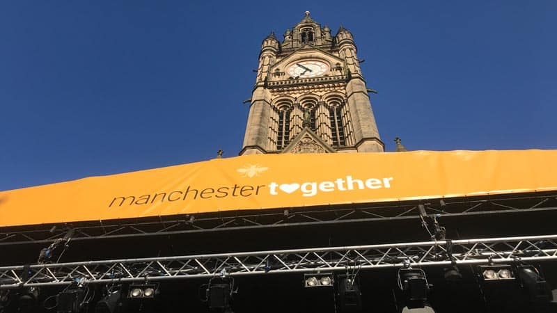 View of Manchester Town Hall clock above the 'Manchester Together' banner