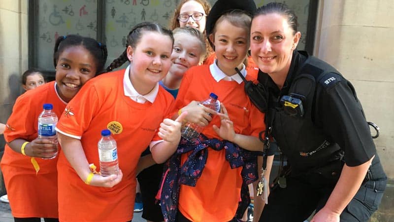 Choir members make friends with a police women.